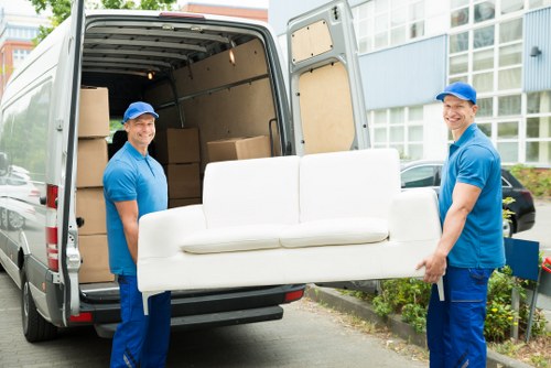 Moving team loading household items into a van