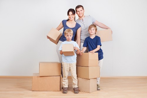 Professional movers navigating a Bayswater property with narrow access